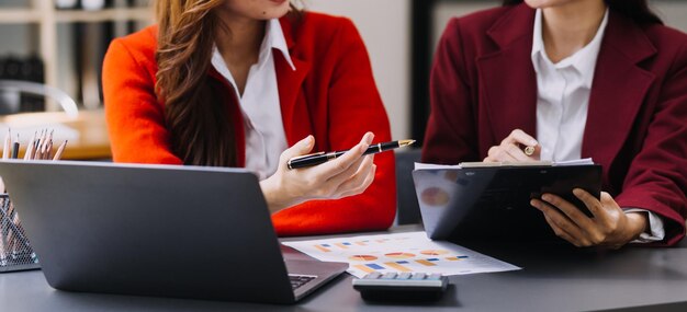 Businessman and team analyzing financial statement Finance task with smart phone and laptop and tablet Wealth management concept