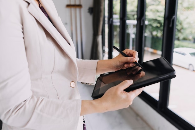 Businessman and team analyzing financial statement finance task\
with smart phone and laptop and tablet wealth management\
concept