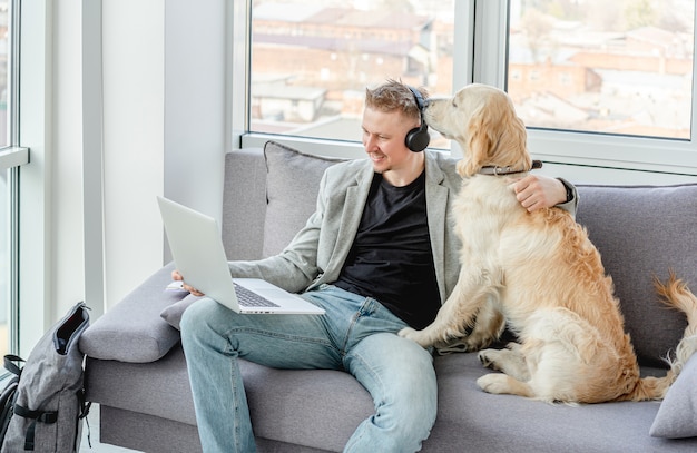 Businessman teleworking next to dog