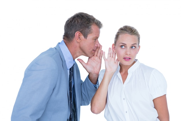  Businessman telling secret to a businesswoman