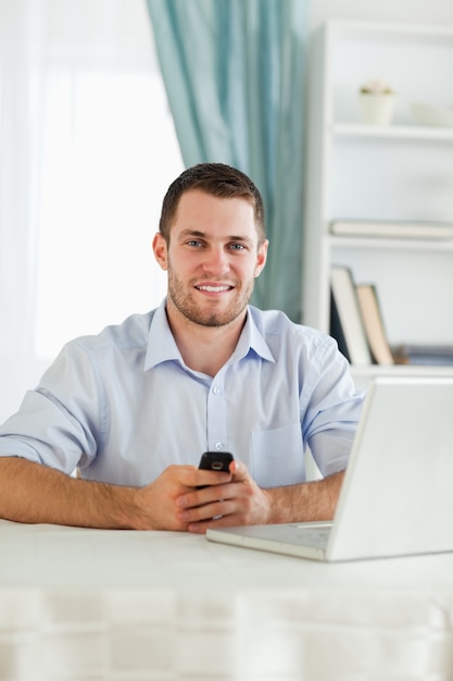 Businessman texting on his cellphone