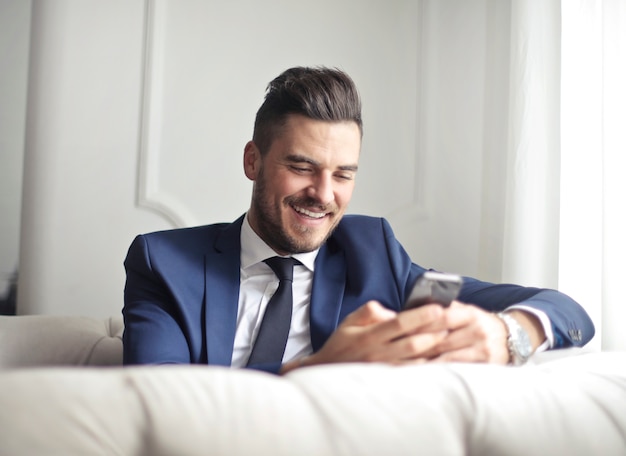 Businessman texting on his phone