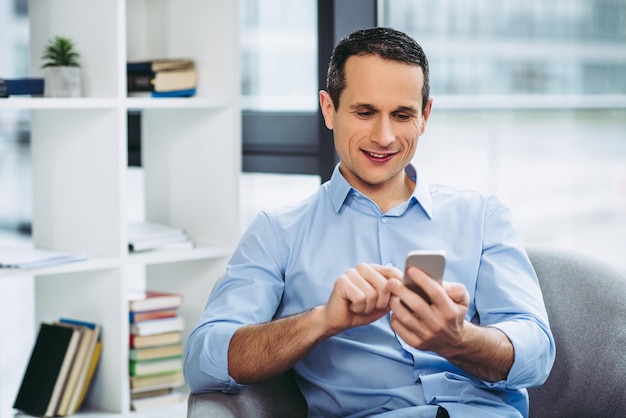 Businessman texting message on the smartphone