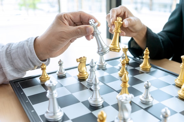 Businessman thinking and hold king chess on his hand,