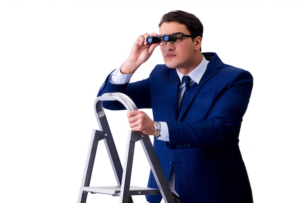 Businessman at top of ladder with binoculars