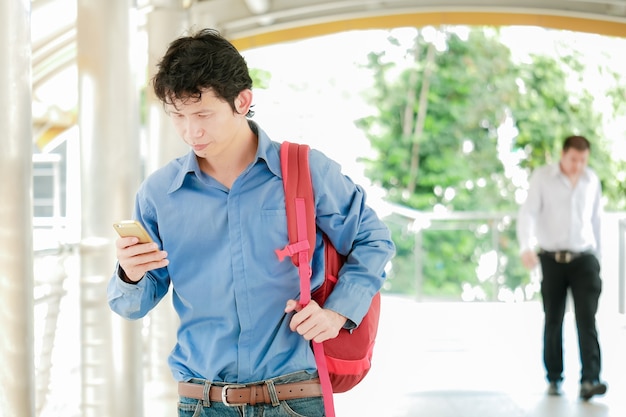 Businessman or tourist holding mobile using smartphone for texting