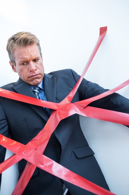 Photo businessman trapped by red tape