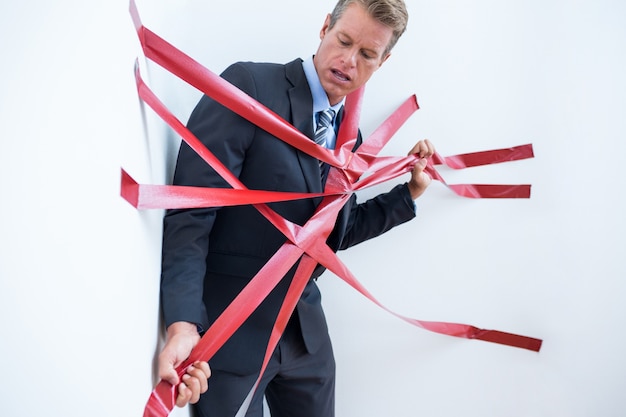 Photo businessman trapped by red tape