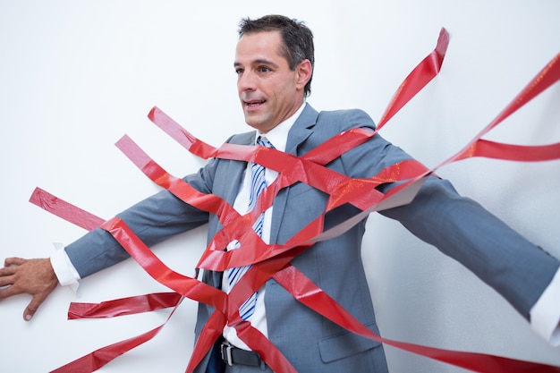 Businessman trapped by red tape