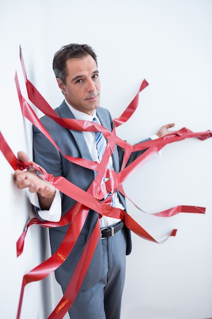 Businessman trapped by red tape