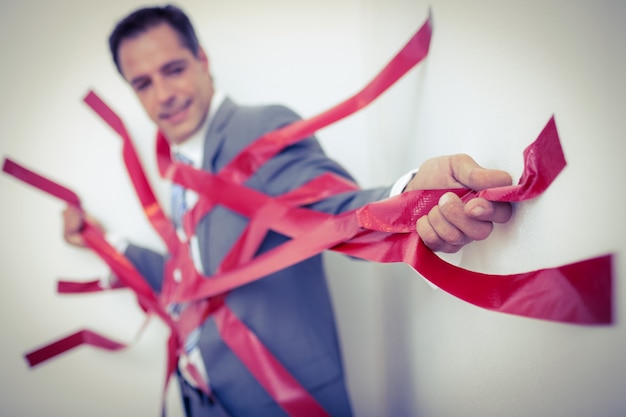 Photo businessman trapped by red tape