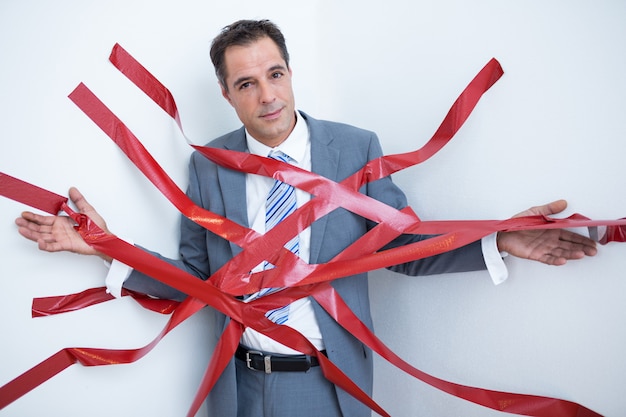 Businessman trapped by red tape