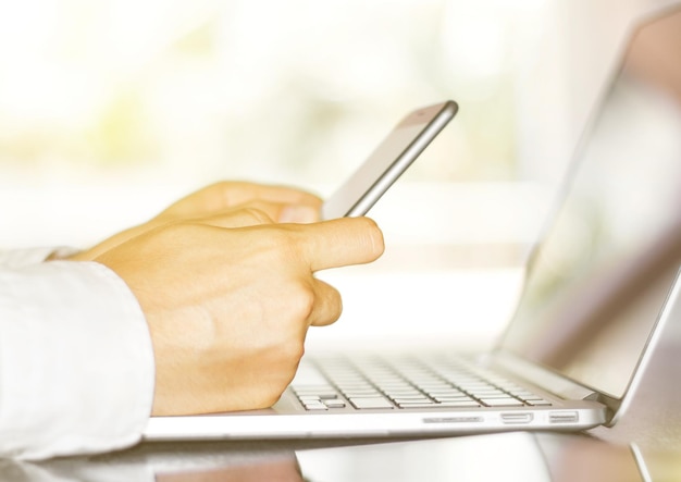 Businessman typing on a cellphone