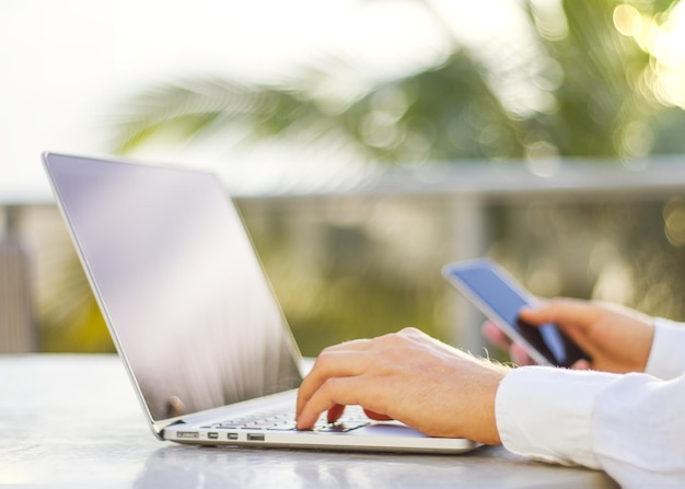 Businessman typing on a cellphone