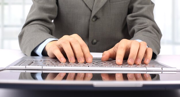 The businessman typing on his laptop in the office