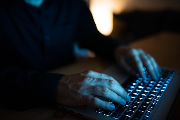 Businessman typing recent updates on lap top keyboard on desk\
man in office writing important message on computer executive\
inserting crutial data into pc