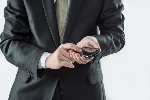 Businessman typing SMS on smartphone