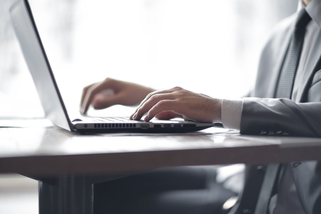 businessman typing text on laptop