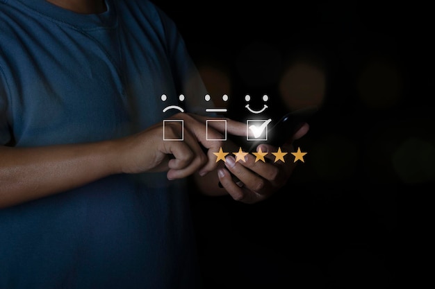 Businessman use smartphone choosing screen on five star icon to give satisfaction in service rating very impressed Customer service experience Concept of customer service and satisfaction