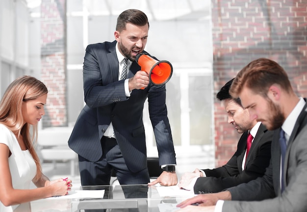 Businessman uses a megaphone to talk to a business team