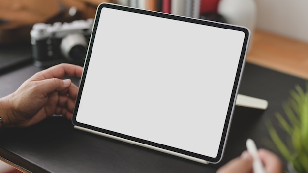 businessman using blank screen tablet in modern office room