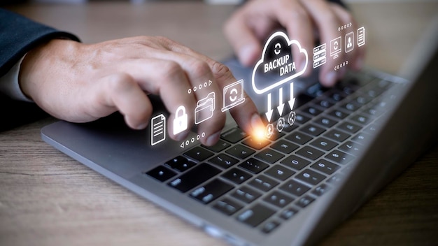 businessman using a computer to backup storage data internet technology concept for backup online documentation database and digital file storage system or softwarefile access doc sharing