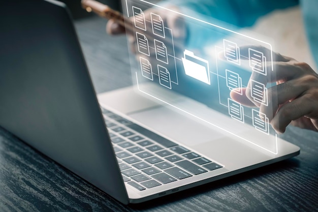 businessman using computer laptop on e document on digital tablet esigning on e document and virtual notepad on virtual screen electronic signature paperless office concept