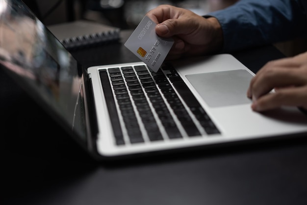 businessman using credit card and laptop to login to internet bankOnline shopping ecommerce internet banking and financial transactions payments via ebank application concept