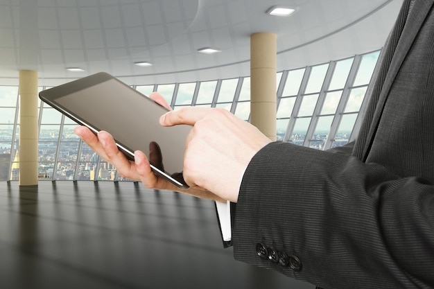 businessman using digital tablet in empty room