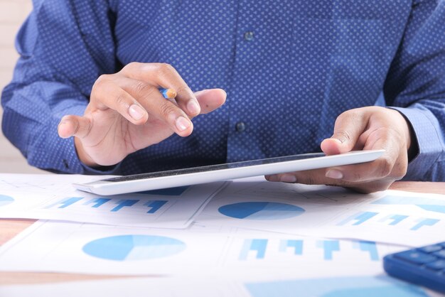 Businessman using digital tablet on office desk