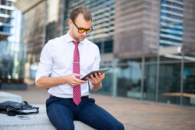 Businessman using a digital tablet in an urban environment