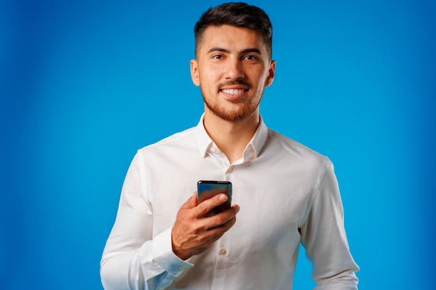 Businessman using his smartphone and smiling