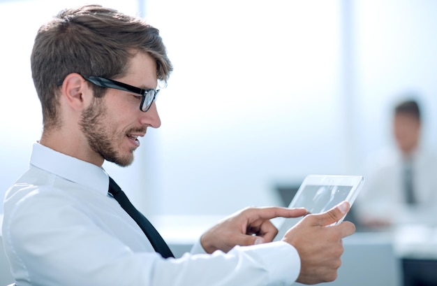 Businessman using his tablet in the office