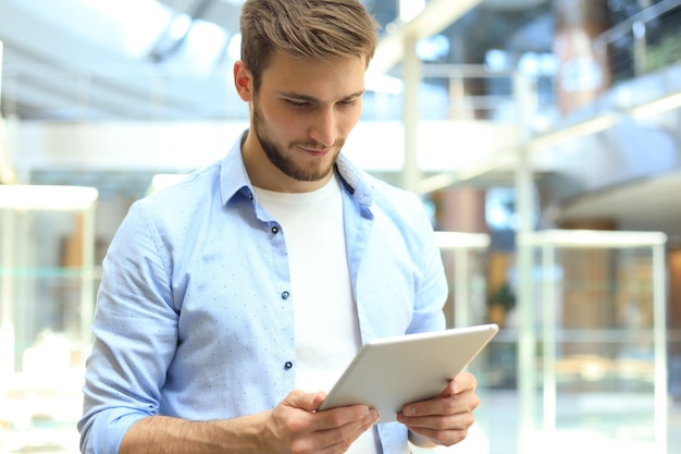 Businessman using his tablet in the office.