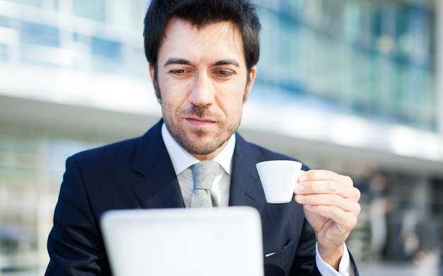 Businessman Using Laptop In Coffee Shop