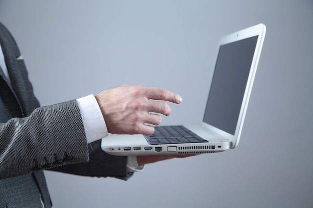 Businessman using laptop computer in office.