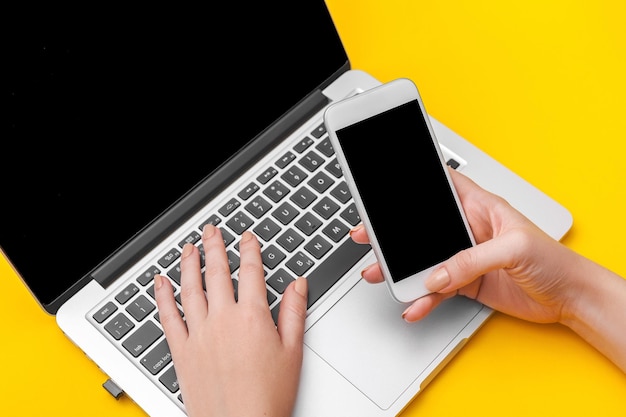 Businessman using laptop and mobile phone