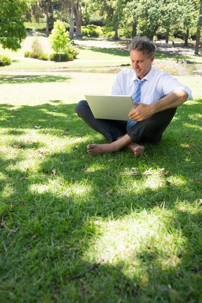 Businessman using laptop outdoors