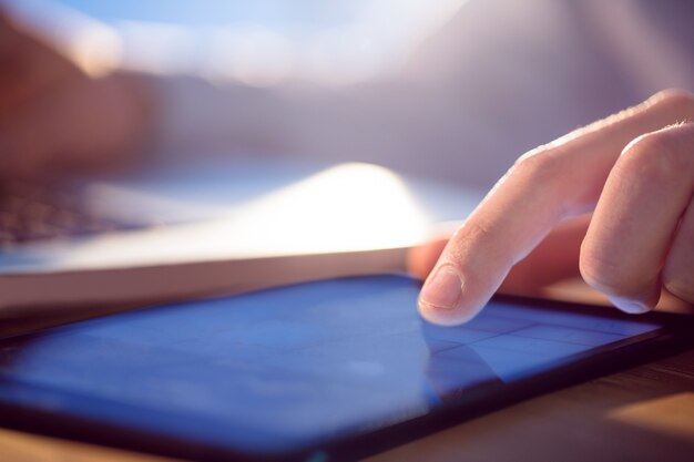 Businessman using laptop and tablet at desk