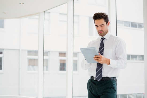 Businessman using laptop and taking notes