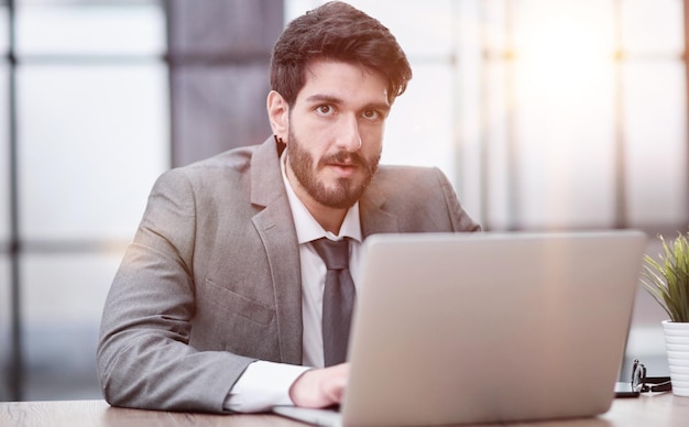 Businessman using a laptop while working late in his office