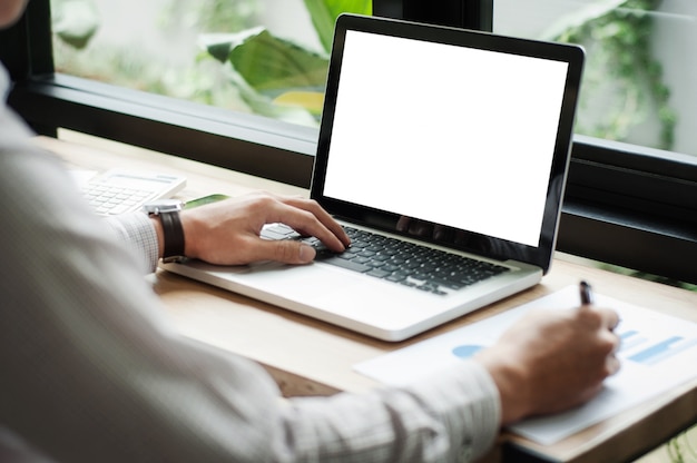 businessman using laptop with blank screen at cafe