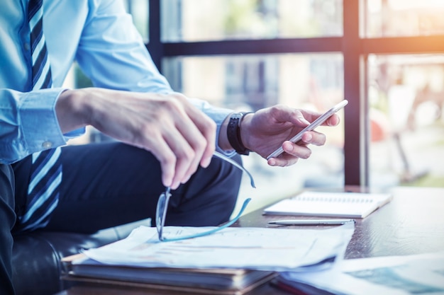 Businessman using mobile checking in office