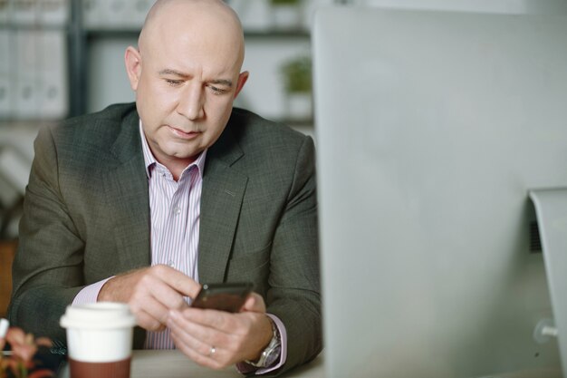 Businessman using mobile phone at office