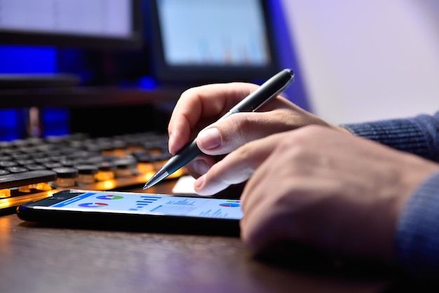 Businessman using mobile phone with stock chart