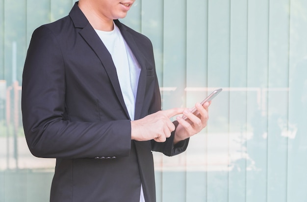 Businessman using smart phone. At the front of the home office background.Concept of young people working mobile devices.