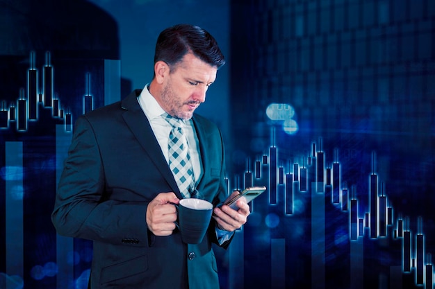 Photo businessman using smartphone and holding cup of coffee over candlestick chart background