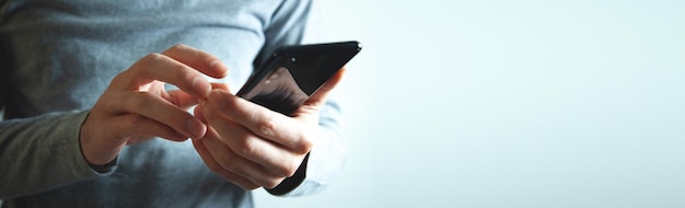 Businessman using smartphone on isolated gray background