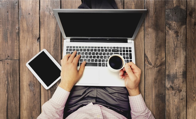 Businessman using smartphone and laptop on background