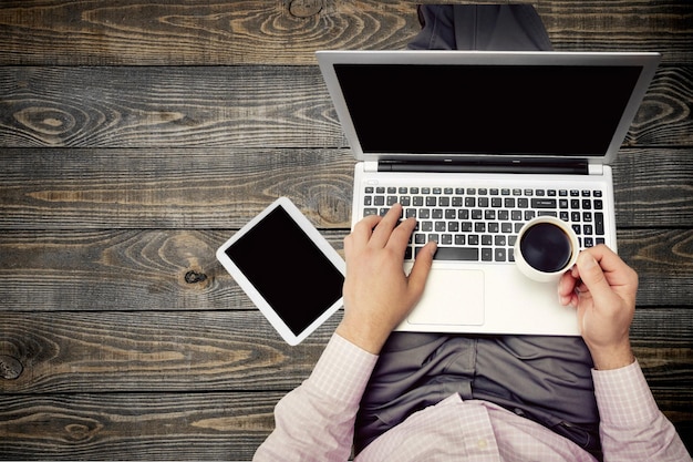 Businessman using smartphone and laptop on background